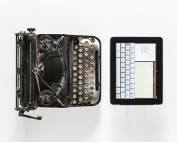 an old typewriter and a modern tablet